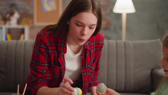 Girl and Little Sister Apply Paint on Eggs with Ebru Decor