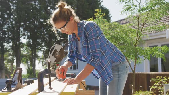 Woman in self isolation in quarantine during coronavirus pandemic does outdoor work