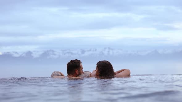 Couple Staring at Each Other With the View of the Snowcapped Mountains