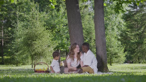 Black Father Fairskinned Mother and Mestizo Child in the Park