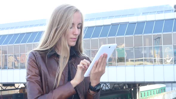 Beautiful Woman Using Tablet In Town