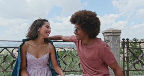 Romantic Couple Sitting on Bench Talking Feeling Free and Happy To the Main Square in Rural Town of