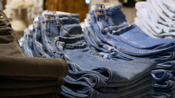 A Shelf with Jeans of Various Models and Colors in a Clothing Store