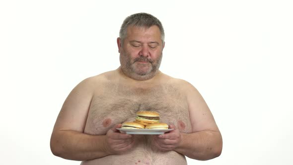 Fat Man Enjoying Smell of Burgers