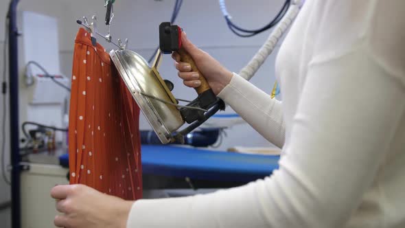 Female Hands Ironing Skirt in Dry-cleaning Salon