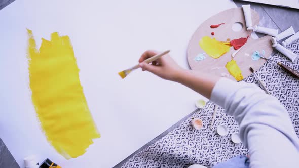 Woman Mixes Paint on Palette and Applying on Paper