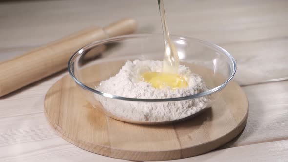Slow Motion of Falling Eggs Into Flour Stock. Footage Food. Egg Dropping Into Flour, Slow Motion.