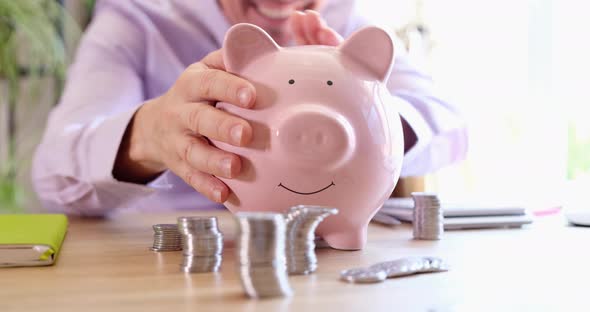 Happy Joyful Satisfied Man Shakes Piggy Bank