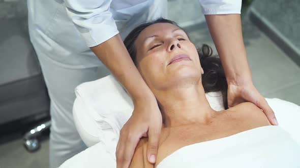 Cute Beautician Is Making Gentle Traditional Shoulder Massage