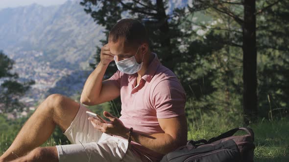 Man Travel and Removing Medical Face Mask and Breathing Air in Mountains