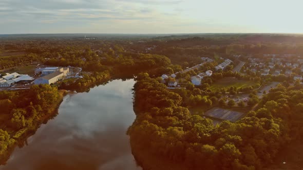 Colorful Sunset Over the City Top View of the River By Trees and Meadows