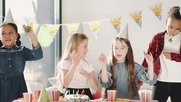 Group of Children Celebrating Birthday Party at Decorated Home