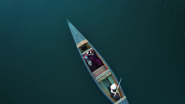 Aerial View Woman Traveling By Boat at Sunset