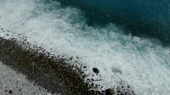 Aerial view of waves crashing along the coast, Madeira, Portugal. alt