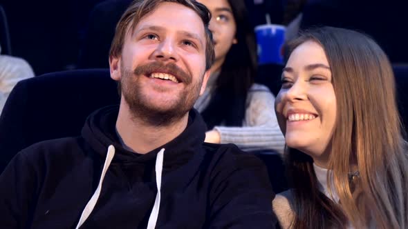 Couple Looks at Each Other at the Movie Theater