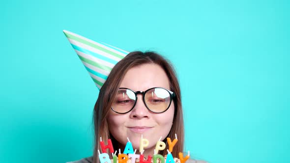 Concept of Celebration and Fun. Young Cheerful Funny Girl with a Birthday Cake