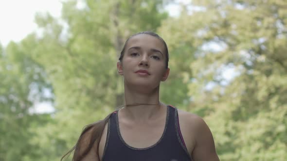 Confident Long Haired Beautiful Woman Runs in Sport Outfit, Slow Motion Outdoor