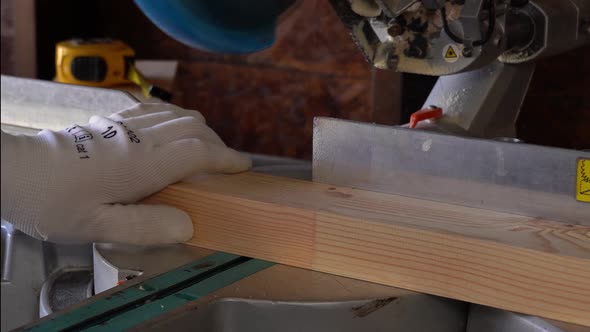 Closeup of Professional Cabinet Makers Working with Electric Circular Saw at Woodworking Workshop