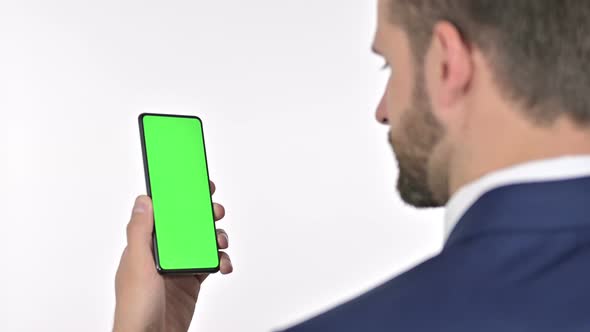 Businessman Scrolling on Smartphone with Chroma Screen, White Background