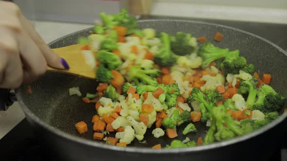 Adding Flavoring To Vegetables on Frying Pan. Carrots, Cauliflower, Broccoli