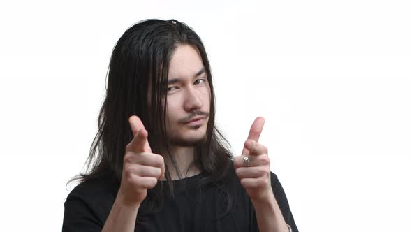 Closeup of Young Eastasian Rocker Man with Moustache and Long Dark Hair Praising you Pointing