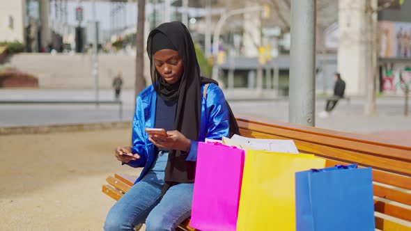 Muslim Female Making Online Order on Street