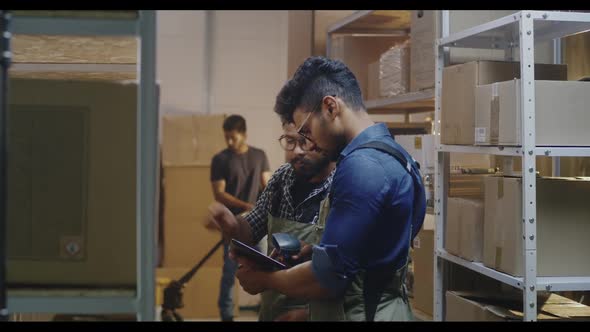 Workers Checking Boxes in a Distribution Center