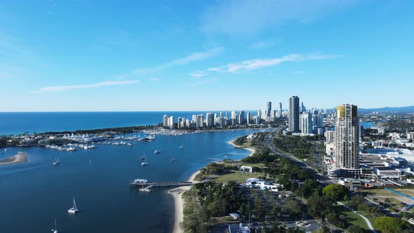 High revealing aerial view of a coastal urban metropolitan sprawl with a towering high-rise skyline