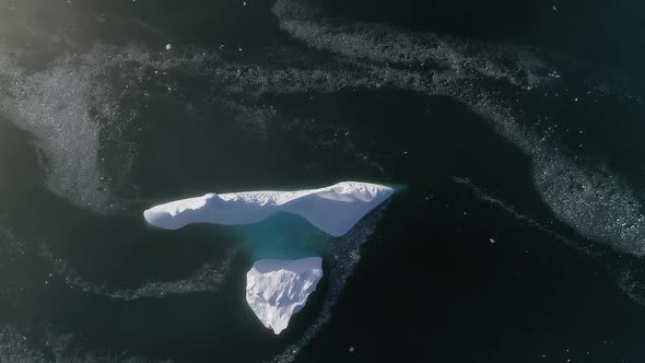Top Down View Antarctic Iceberg. Aerial Flight.