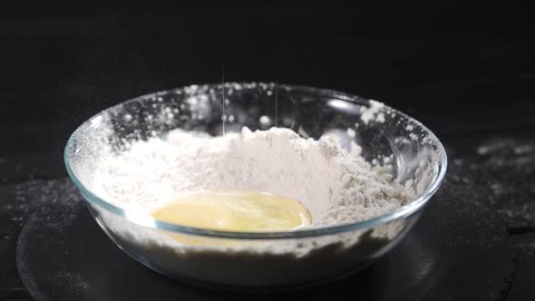 Egg Falls on a Pile of Flour. Shot with High Speed Camera, Slow Motion.