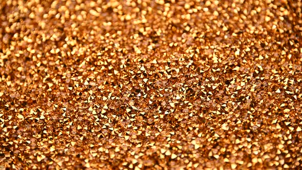 Abstract background of golden rhinestones spinning