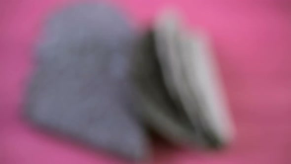 Blue corn taco shells on a pink background.