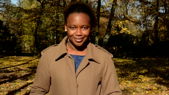 Young Beautiful African Happy Girl Stand in Woods, Stare To Camera and Nods Head