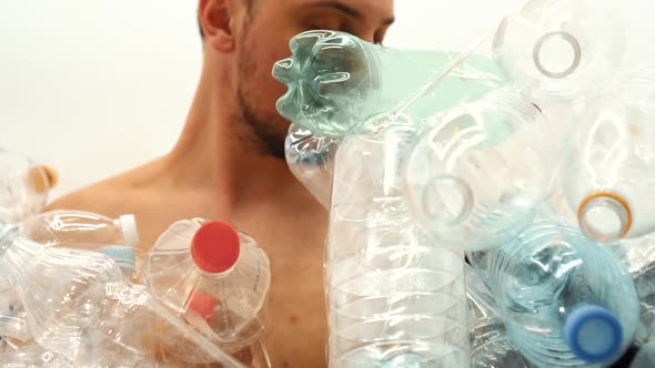 Man Sitting in a Pile of Plastic