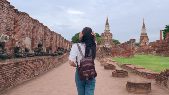 Japanese backpacker female enjoy her journey at amazing landmark in traditional city.