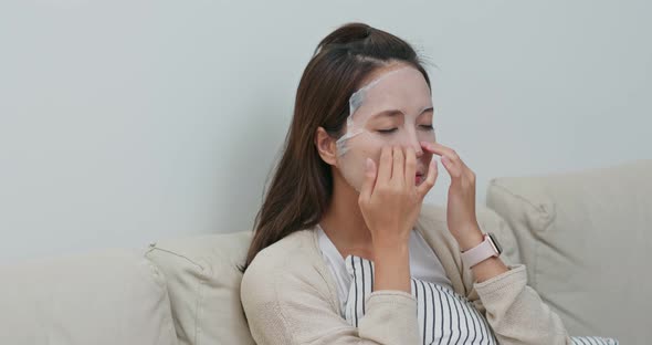Woman apply face mask at home