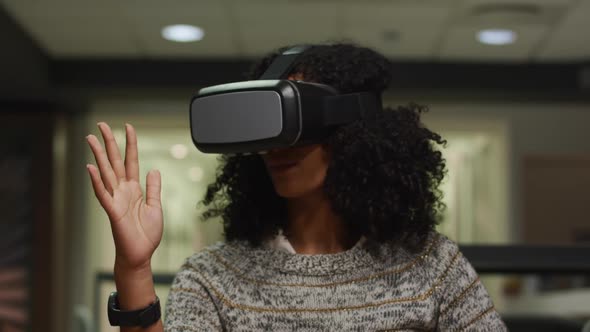 Businesswoman using VR helmet in a modern office