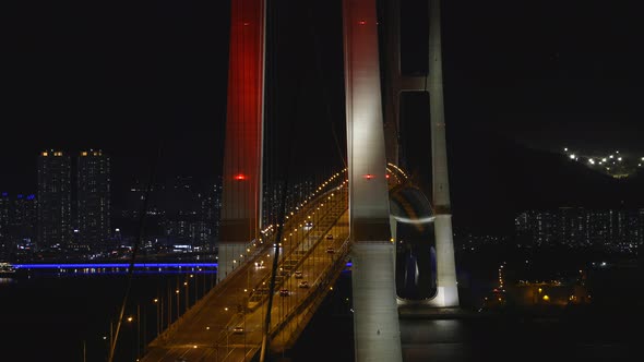 cars driving through over the bridge at night. lights of the bridge are beautiful.