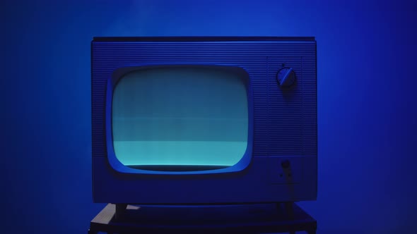 Old Vintage Television on Blue Neon Background Closeup