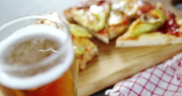 Delicious pizza with a glass of beer