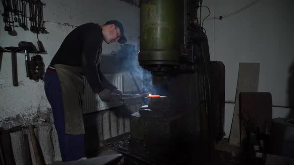 Blacksmith Shaping Hot Metal Using Forging Press