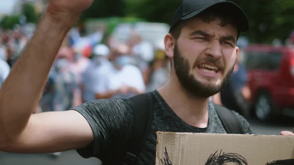 Face portrait of man on opposition political rally with placard banner shouts.