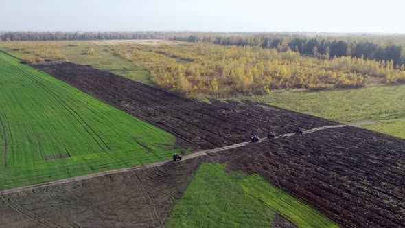 Active Leisure Offroad Trains on QUAD Atv Bikes on a Field Through the Forest View From a Quadcopter