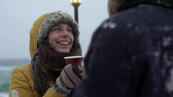 Portrait of Happy Smiling Young People Man and Woman Drinking Tea or Coffee From Paper Cups While