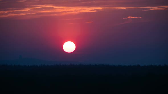 Sunset Over the Trees and Clouds