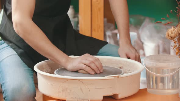 Pottery - the Master Is Putting a Piece of Clay on the Potter's Wheel