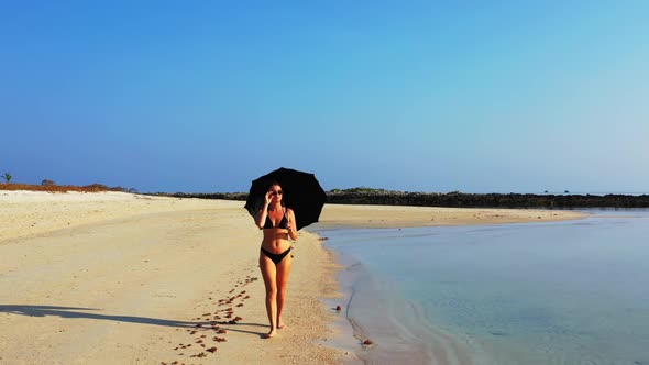 Women tanning on tranquil lagoon beach journey by aqua blue water with white sandy background of Koh