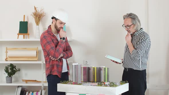 Young Engineer Man Mastering New Knowledge By Professional Architect