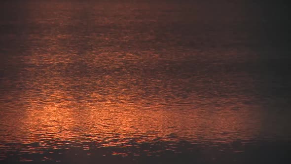 Early morning sun reflecting on fresh water lake.