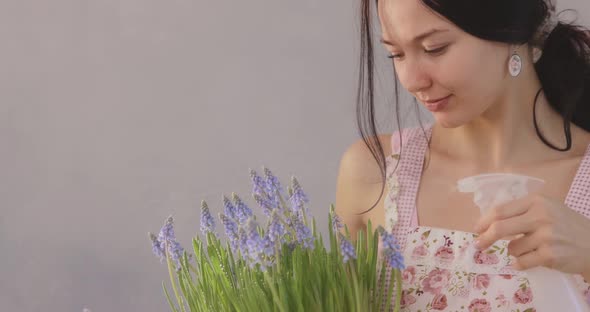 Woman Holding Bouquet of Flowers in Hands Indoors